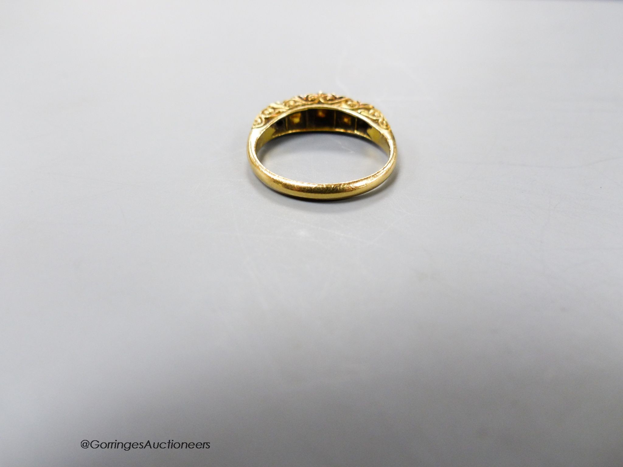 An early 20th century 18ct, three stone rose cut diamond and two stone olivine? set half hoop ring, size N/O, gross 3.5 grams.